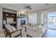 Comfortable living room with stone fireplace, neutral decor, and plenty of natural light at 27587 N Makena Pl, Peoria, AZ 85383