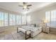 Serene bedroom with a large bed, neutral tones, and multiple windows with shutters at 27587 N Makena Pl, Peoria, AZ 85383