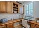 Home office featuring custom wood built-ins and a bright window with natural light at 27587 N Makena Pl, Peoria, AZ 85383