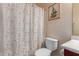 Bathroom featuring a toilet, shower with decorative curtain and framed art at 3468 E Desert Moon Trl, San Tan Valley, AZ 85143