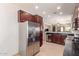 Bright kitchen showcases stainless steel refrigerator and open layout at 3468 E Desert Moon Trl, San Tan Valley, AZ 85143