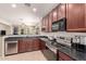 Well-lit kitchen features stainless steel appliances, granite countertops, and wood cabinetry at 3468 E Desert Moon Trl, San Tan Valley, AZ 85143