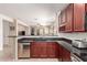 Well-appointed kitchen with dark cabinetry and open layout leading to the adjacent living spaces at 3468 E Desert Moon Trl, San Tan Valley, AZ 85143