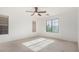 Bright bedroom with large window and ceiling fan at 4354 E Rosemonte Dr, Phoenix, AZ 85050