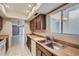 View of kitchen with wood cabinets and a double sink at 13235 N 25Th Dr, Phoenix, AZ 85029