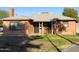 Brick ranch house with a covered porch and a well-maintained lawn at 3021 N 17Th Dr, Phoenix, AZ 85015