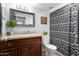 Cozy bathroom featuring a granite-topped vanity and a black and white patterned shower curtain at 3637 E Monterosa St # 17, Phoenix, AZ 85018