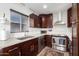 Stylish kitchen featuring dark wood cabinets, modern appliances, and a bright window at 3637 E Monterosa St # 17, Phoenix, AZ 85018