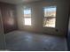 Unfinished bedroom with concrete floors and two large windows at 37909 W Raymond St, Tonopah, AZ 85354