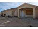 Newly constructed house with a covered porch and unfinished landscaping at 37909 W Raymond St, Tonopah, AZ 85354