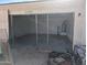 Unfinished garage with open door and concrete floor at 37909 W Raymond St, Tonopah, AZ 85354