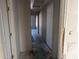 Unfinished hallway with concrete floors and access to other rooms at 37909 W Raymond St, Tonopah, AZ 85354