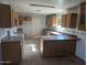 Unfinished kitchen with wooden cabinets and a center island at 37909 W Raymond St, Tonopah, AZ 85354