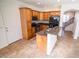 Kitchen with island, wood cabinets, and granite counters at 1131 W Auburn St, Mesa, AZ 85201