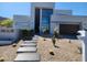 Modern home featuring desert landscaping, a pathway, and a minimalist architectural design at 18475 W Eagle Dr, Goodyear, AZ 85338