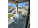 Inviting outdoor seating area with stylish patio furniture, a lush lawn, and a contemporary design at 18475 W Eagle Dr, Goodyear, AZ 85338