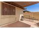 Enclosed back patio with grill, privacy wall, and window with decorative bars at 542 S Higley Rd # 99, Mesa, AZ 85206