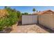 View of a back yard and storage shed with desert landscaping and citrus trees at 542 S Higley Rd # 99, Mesa, AZ 85206