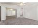 Bedroom with neutral carpet and vaulted ceiling, featuring mirrored closet doors and a door to additional rooms at 542 S Higley Rd # 99, Mesa, AZ 85206