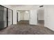 Bedroom featuring carpet, vaulted ceilings, mirrored closet doors, and a door leading to additional rooms at 542 S Higley Rd # 99, Mesa, AZ 85206