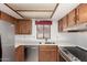 Well-lit kitchen with stainless steel appliances, quartz countertops, and wooden cabinetry at 542 S Higley Rd # 99, Mesa, AZ 85206