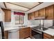 Updated kitchen featuring stainless steel appliances, quartz countertops, and wooden cabinetry at 542 S Higley Rd # 99, Mesa, AZ 85206