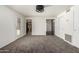 Spacious living room featuring fresh paint, neutral carpet, and exterior access, leading to an open and airy feel at 542 S Higley Rd # 99, Mesa, AZ 85206
