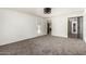 Bright living room featuring neutral paint, carpet, ceiling fan, and glass paneled doors leading outside and to other rooms at 542 S Higley Rd # 99, Mesa, AZ 85206