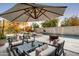 Relaxing patio with umbrella, seating, and fire pit near the pool at 5555 N Camino Del Contento --, Paradise Valley, AZ 85253