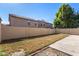 Spacious backyard with a block wall and a large patch of grass, ideal for outdoor activities at 8913 E Oro Cir, Mesa, AZ 85212