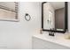 This bathroom features a modern vanity with a black faucet and a large framed mirror at 8913 E Oro Cir, Mesa, AZ 85212