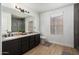 Bright bathroom featuring granite countertops, double sinks, and sleek black cabinetry at 8913 E Oro Cir, Mesa, AZ 85212