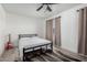 Clean and simple bedroom with a metal frame bed, neutral curtains, and a striking rug at 8913 E Oro Cir, Mesa, AZ 85212