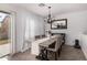 Dining room with wood table and chandelier. Large windows let in ample natural light at 8913 E Oro Cir, Mesa, AZ 85212