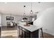 Open concept kitchen with eat in nook, pendant lighting, and black cabinets at 8913 E Oro Cir, Mesa, AZ 85212