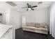 Cozy loft with dark wood flooring, a ceiling fan, and a comfortable beige sofa at 8913 E Oro Cir, Mesa, AZ 85212