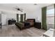 Bright main bedroom with hardwood floors, a ceiling fan, and dark wood accents at 8913 E Oro Cir, Mesa, AZ 85212