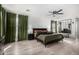 Bright main bedroom with green accents, modern ceiling fan, and hardwood floors at 8913 E Oro Cir, Mesa, AZ 85212