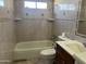 Clean bathroom with tiled walls and bathtub at 2007 N 67Th Dr, Phoenix, AZ 85035