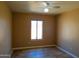 This cozy bedroom has a ceiling fan and natural light to create a relaxing atmosphere at 2007 N 67Th Dr, Phoenix, AZ 85035