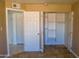 A bedroom with an open closet provides ample storage space at 2007 N 67Th Dr, Phoenix, AZ 85035