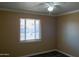 This cozy bedroom has a ceiling fan and natural light to create a relaxing atmosphere at 2007 N 67Th Dr, Phoenix, AZ 85035