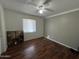 Bright bedroom with wood-look flooring and ceiling fan at 2007 N 67Th Dr, Phoenix, AZ 85035