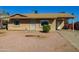 Charming single-story home with desert landscaping and a covered carport for convenient parking at 2007 N 67Th Dr, Phoenix, AZ 85035