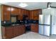 This kitchen boasts wood cabinets, sleek black countertops, and modern stainless-steel appliances at 2007 N 67Th Dr, Phoenix, AZ 85035