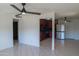 A bright living room showcases neutral walls, tile floors, and an open layout into the kitchen at 2007 N 67Th Dr, Phoenix, AZ 85035