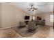 Inviting living room with neutral tones, ceiling fan, and stylish furniture arrangement at 44043 W Cypress Ln, Maricopa, AZ 85138