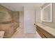 Bright bathroom featuring a glass enclosed shower, soaking tub, and undermount sink with wood cabinets at 5000 E Camelback Ridge Rd # 204, Scottsdale, AZ 85251