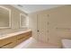 Well-lit bathroom featuring double sinks with lighted mirrors, ample counter space, and modern fixtures at 5000 E Camelback Ridge Rd # 204, Scottsdale, AZ 85251