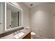 Modern bathroom featuring a lighted mirror, stone countertop, a glass shower, and neutral paint at 5000 E Camelback Ridge Rd # 204, Scottsdale, AZ 85251